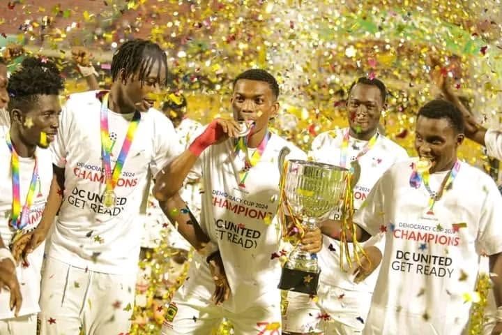 Kotoko players celebrate with the trophy in gold confetti