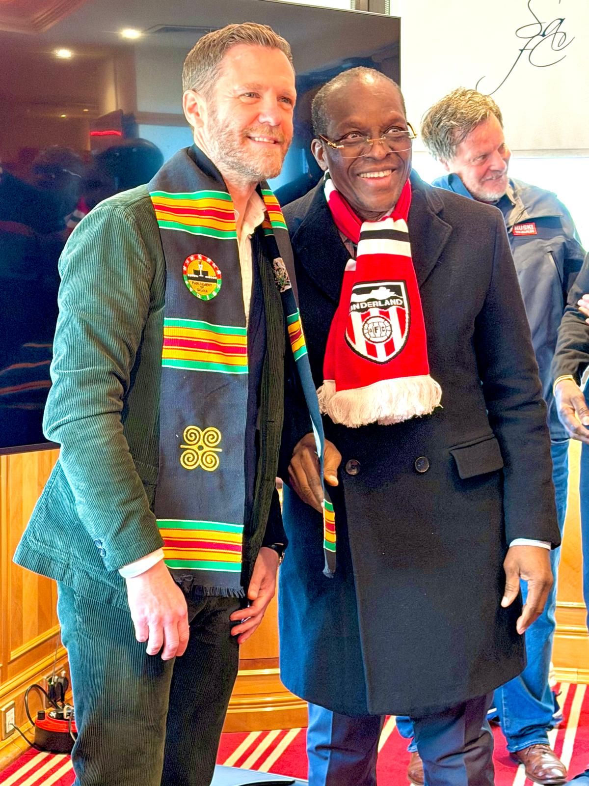 Delegation members in club scarves
