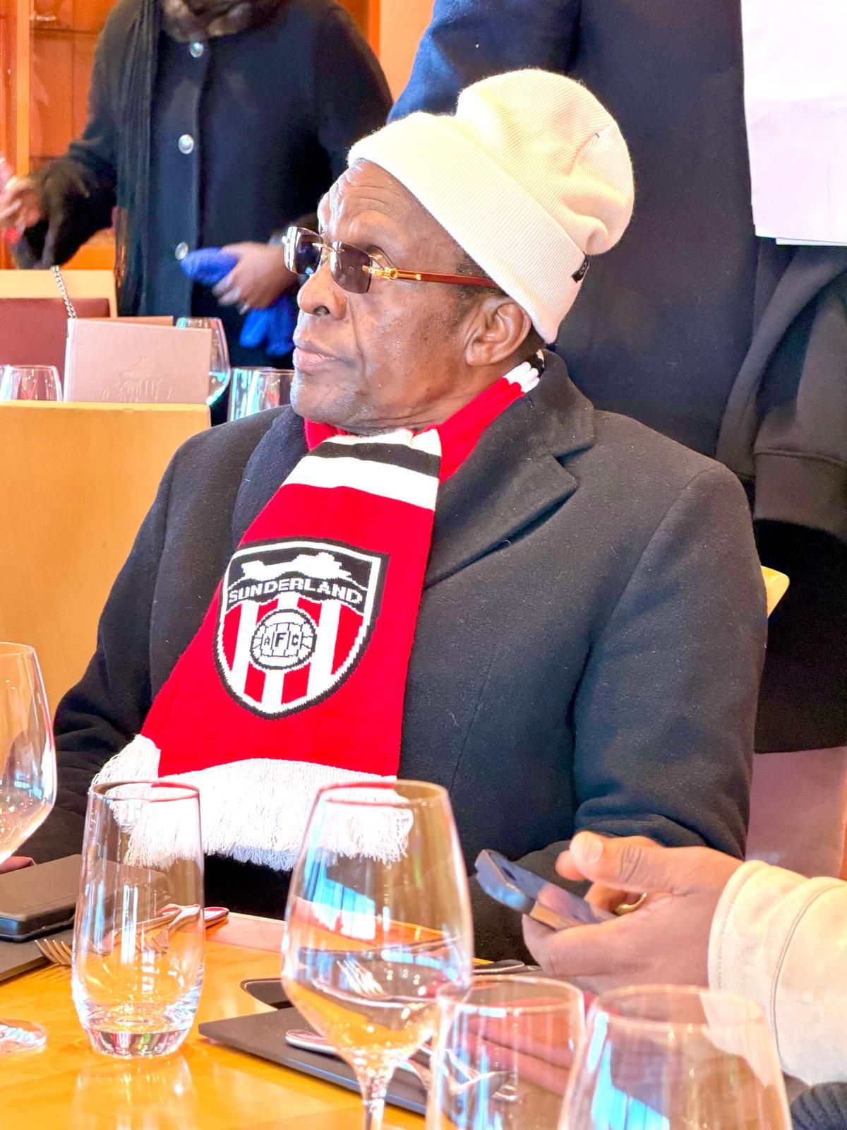 Delegation elder in club scarf