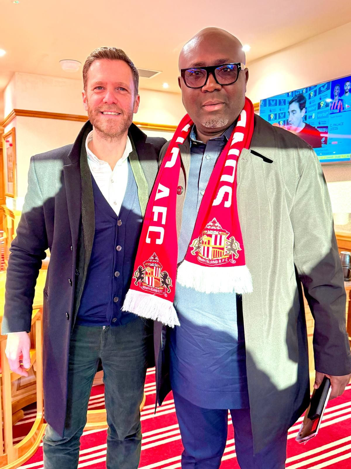Delegation member with host at the stadium
